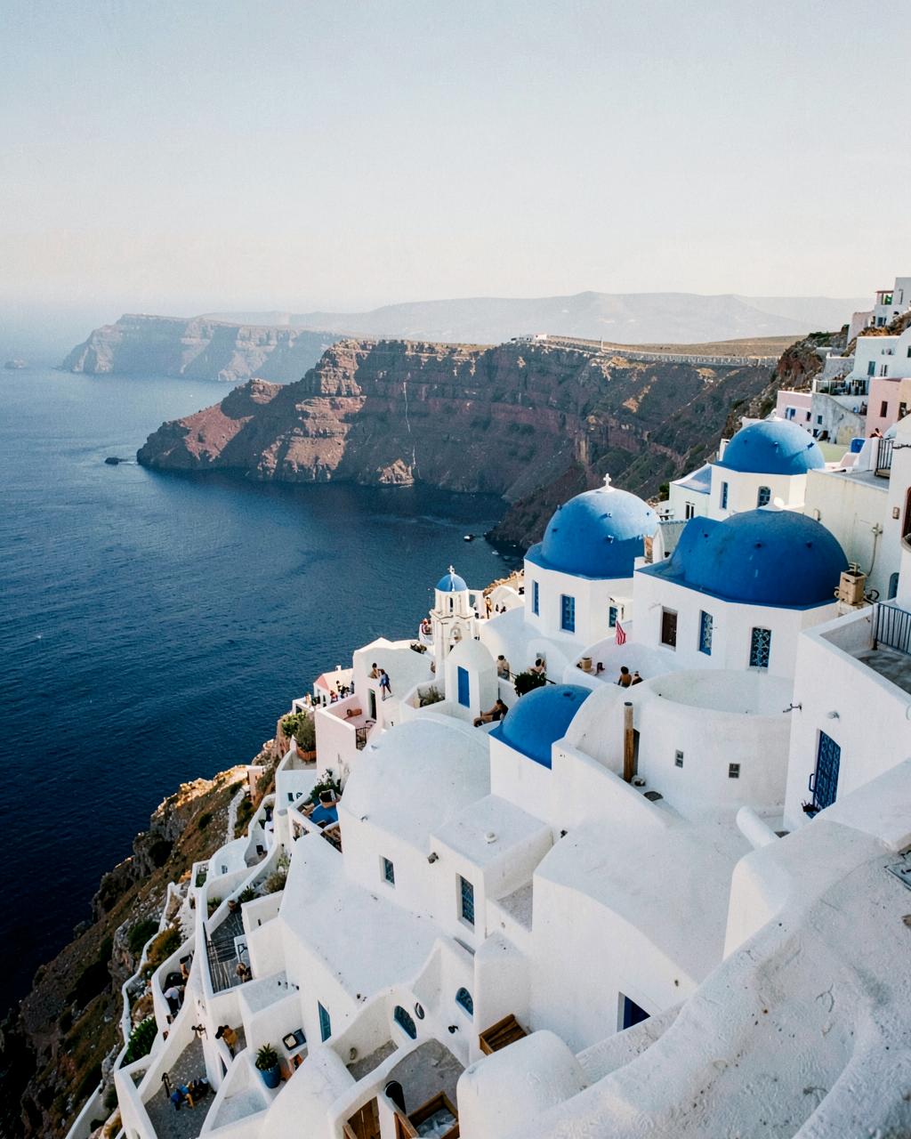 White houses and blue domes above the Aegean sea